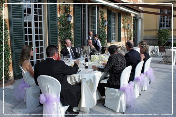 White tablecloths and chairs hydrangea and roses decorations with some