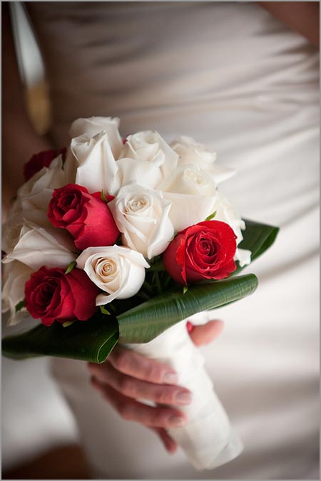 Red was in bridal and bridesmaids' bouquet groom's tie and buttonholes and