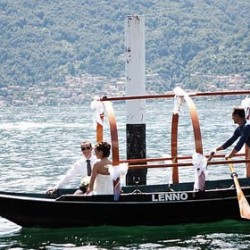 Getting married at Lake Como, bride and groom arrive by traditional row-boat "Lucia"