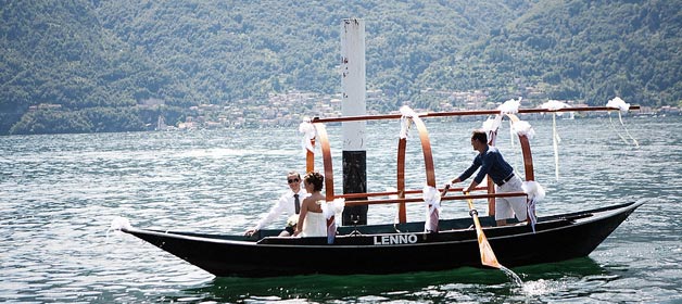 Getting married at Lake Como, bride and groom arrive by traditional row-boat “Lucia”